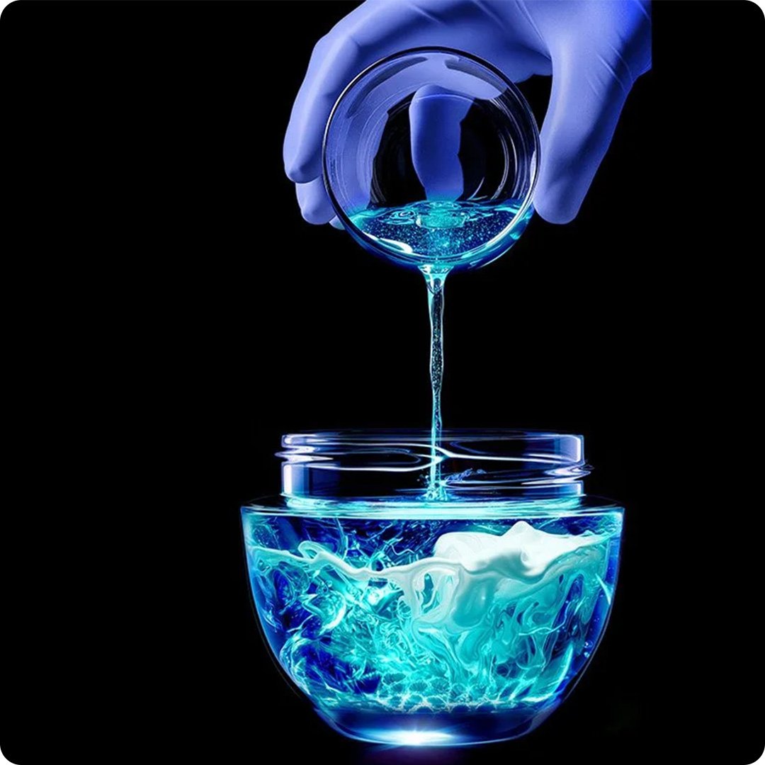 beauty full of science  hand pouring blue scientific liquid kv desk