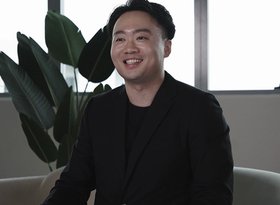 2026TravelRetail524239InterviewCheng Zhong smiling while seated in a lounge
