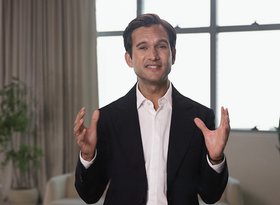 2026TravelRetail524243InterviewJesus Abia speaking to camera with hands raised in a bright lounge