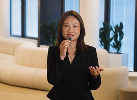 2026TravelRetail524244InterviewMaggie Liu speaking into a microphone in a lounge