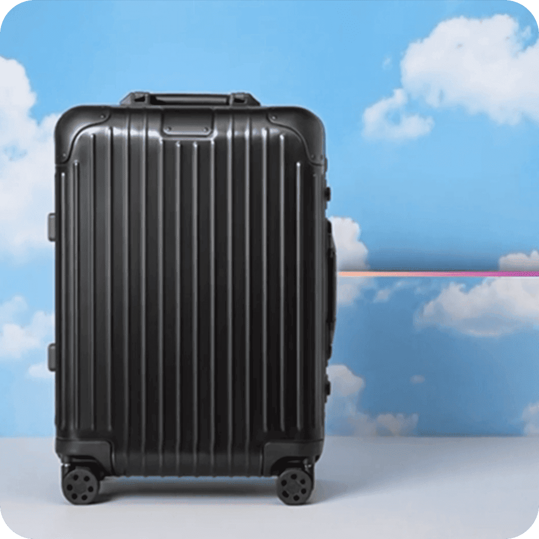 2026TravelRetail524250TravelLuggageBlack suitcase against a blue sky and clouds with a pink horizont