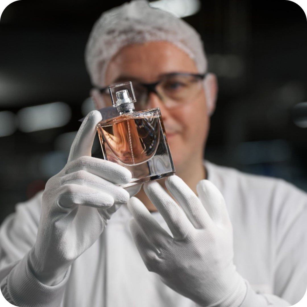 Lancome Man in white Lab Coat with Fragrance La Vie Belle