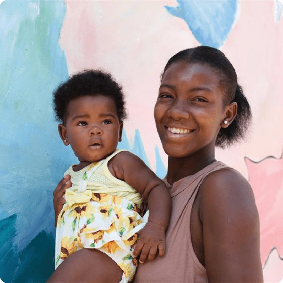 Loreal Fund For the Women Black Woman Holding a Baby Smiling