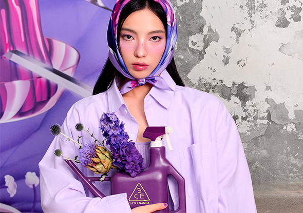 2026 consumer product division 3CE woman wearing purple shirt and scarf carrying flowers