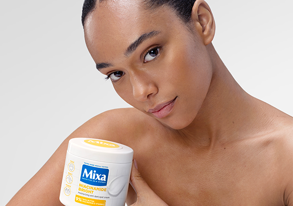 2026 consumer product division brands woman holding mixa niacinamide bright cream