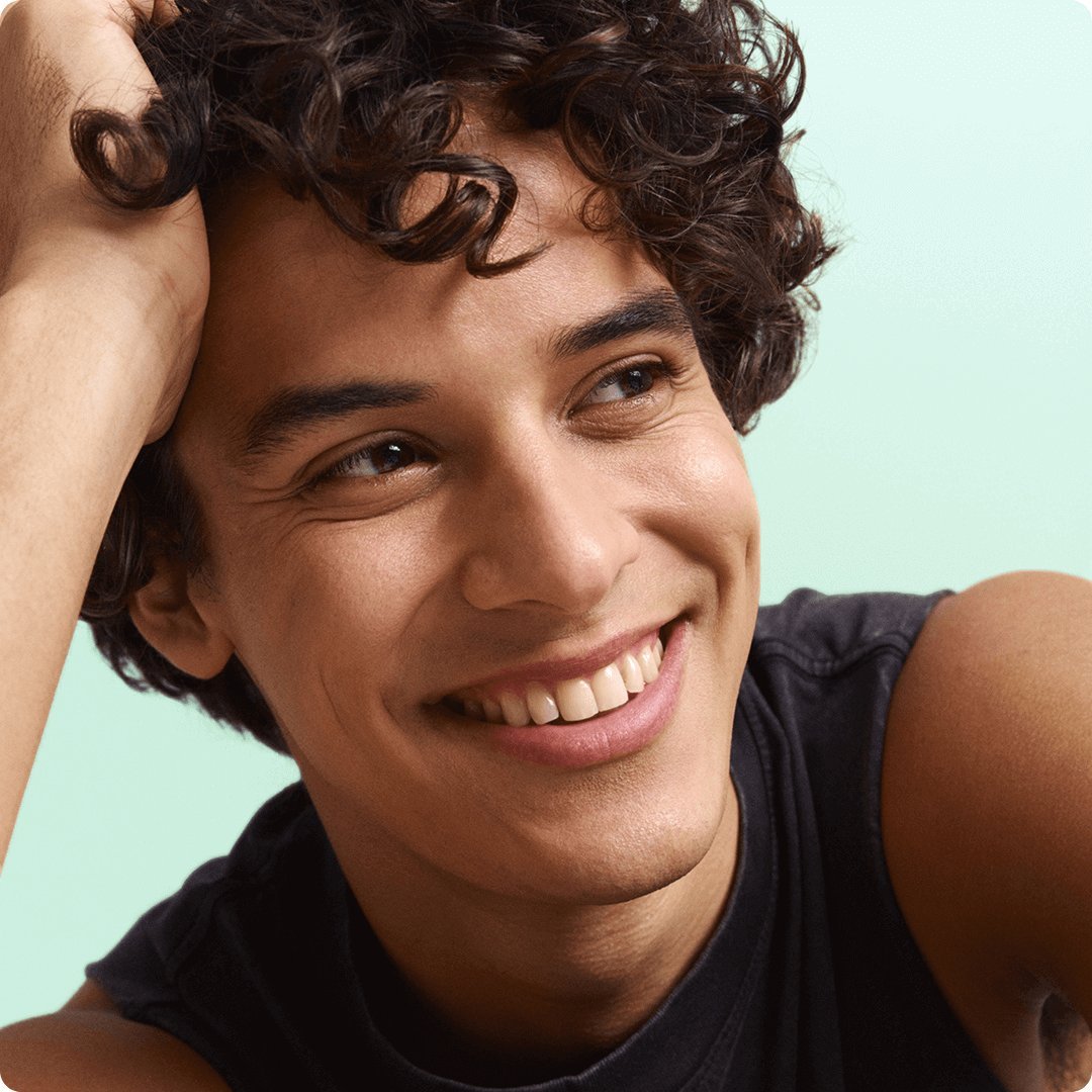 2025 consumer product division brand garnier man with curly hair and dimples