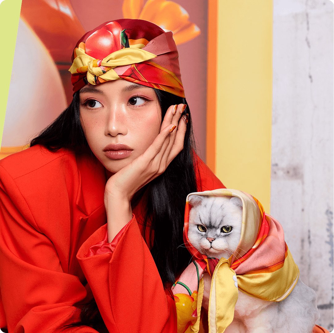 2025 consumer product division 3CE brand woman in orange blazer and scarf with cat wearing the scarf