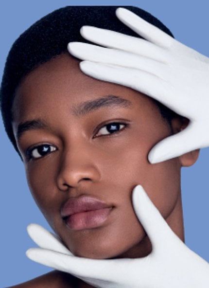 2026 dermatological beauty division black woman examining her face skin herobanner mobile