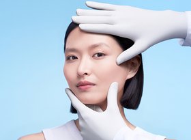 2026 dermatological beauty division white woman examining her face skin herobanner desktop