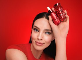 2026dermatologicalbeautydivisionwomaninredtopstraighthairholdingredvichycollagenandserumbottles