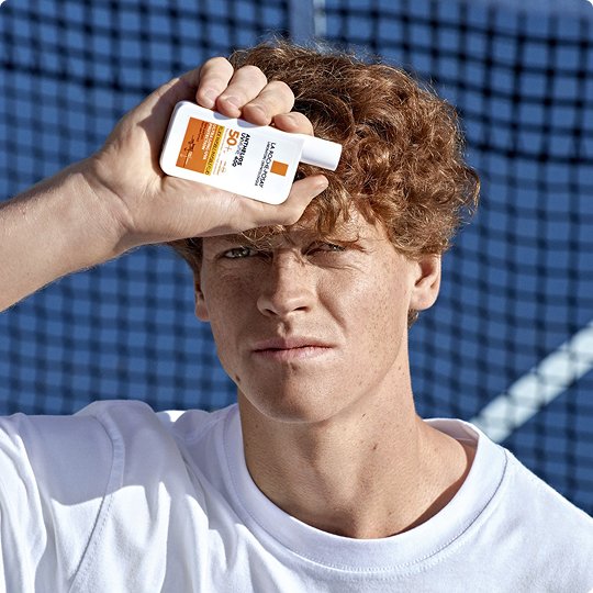 2025 la roche posay brand brown hair with freckles men holding anthelios uvmune 400 spf 50 plus