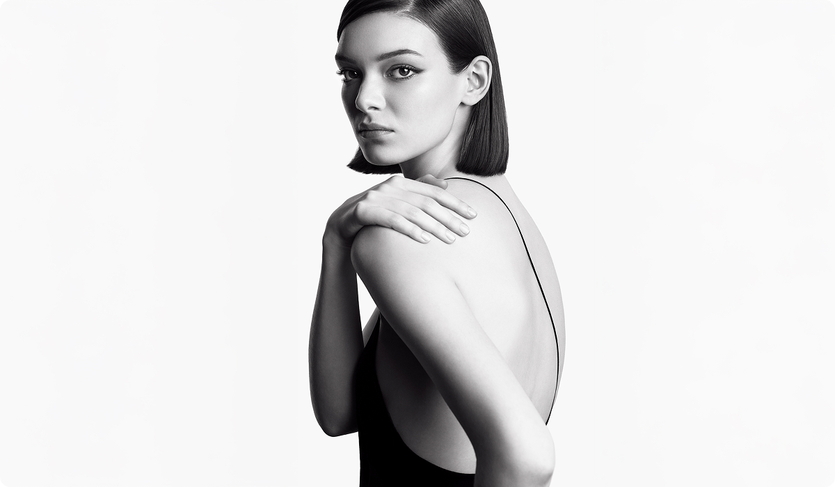 2025 loreal luxe brand carita woman in straight short black hair wearing backless black dress