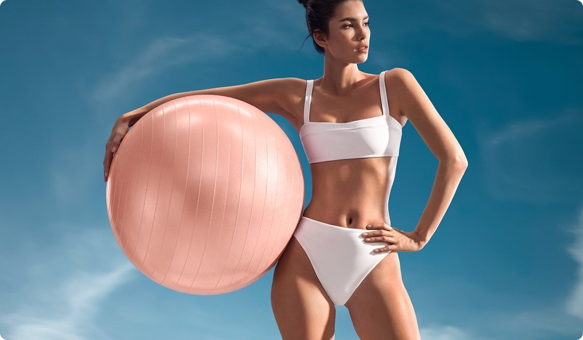 2025 biotherm luxe women holding large pink ball standing