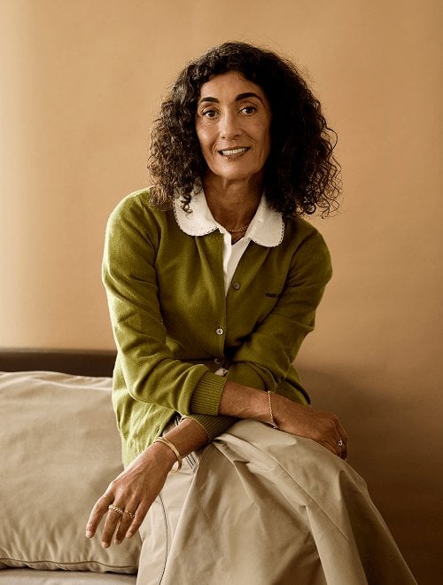 2025 miu miu luxe brand president sitting in green miu miu cardigan