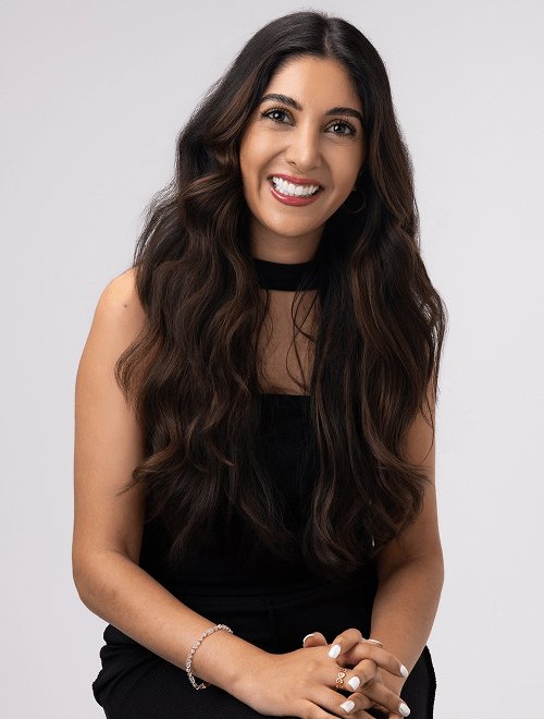 2025 urban decay luxe brand woman in black dress sitting and smiling president