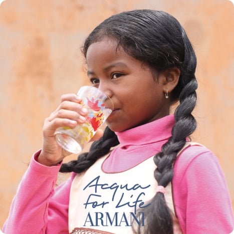 2026 loreal luxe brand armani brown girl in braids pink top holding a glass drinking